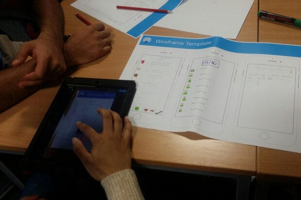 image of student writing on a wireframe template document