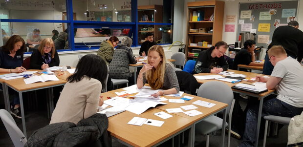 students sitting in groups at desks