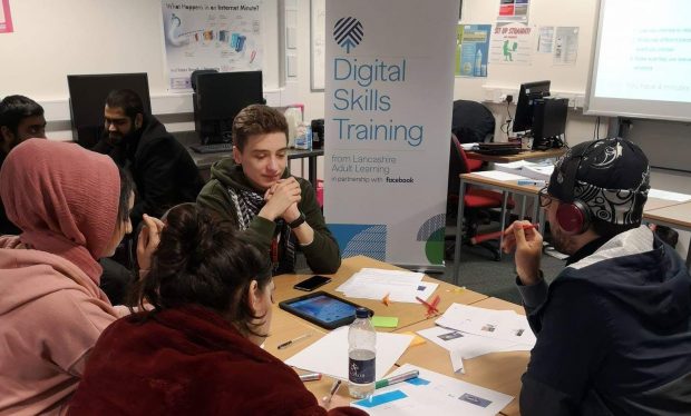 students taking part in Digital Skills Training session with banner in background